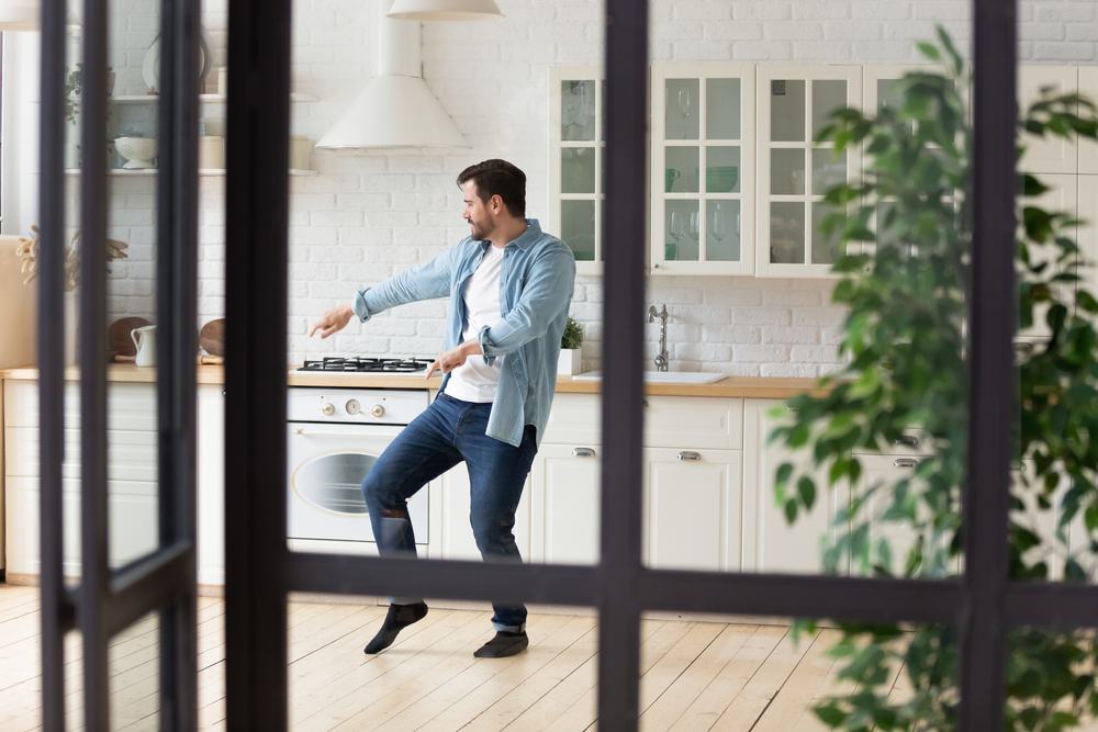 Funny,Positive,Man,Dancing,In,Modern,Kitchen,Alone,,Moving,To June Homeownership Month